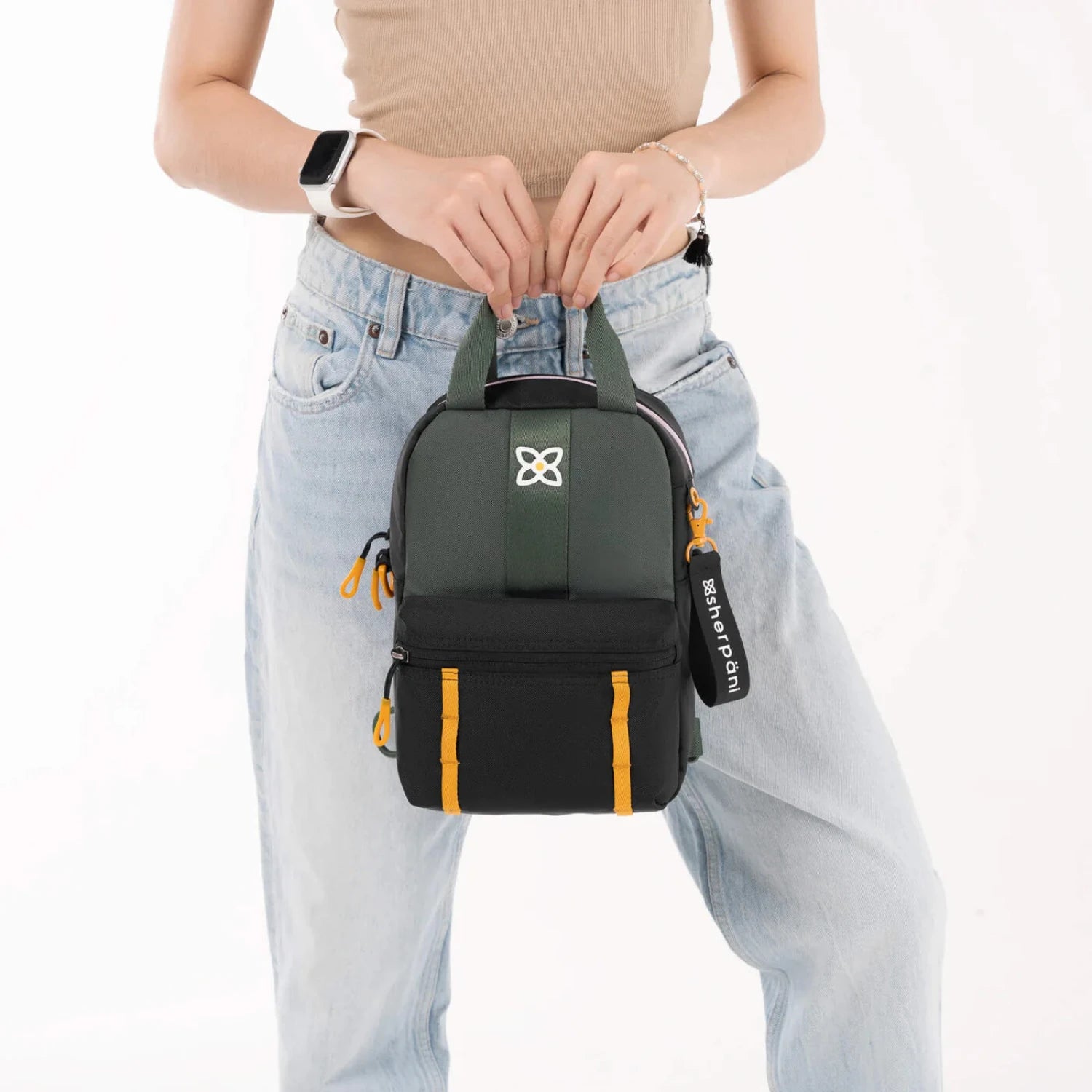 Sherpani Logan Mini Backpack, Juniper, front view of model holding the bag 