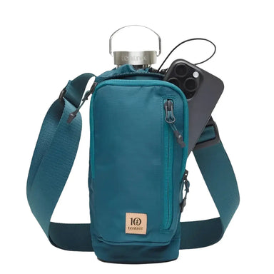 Tentree Trail Sling in jasper, phone pocket open & holding a water bottle