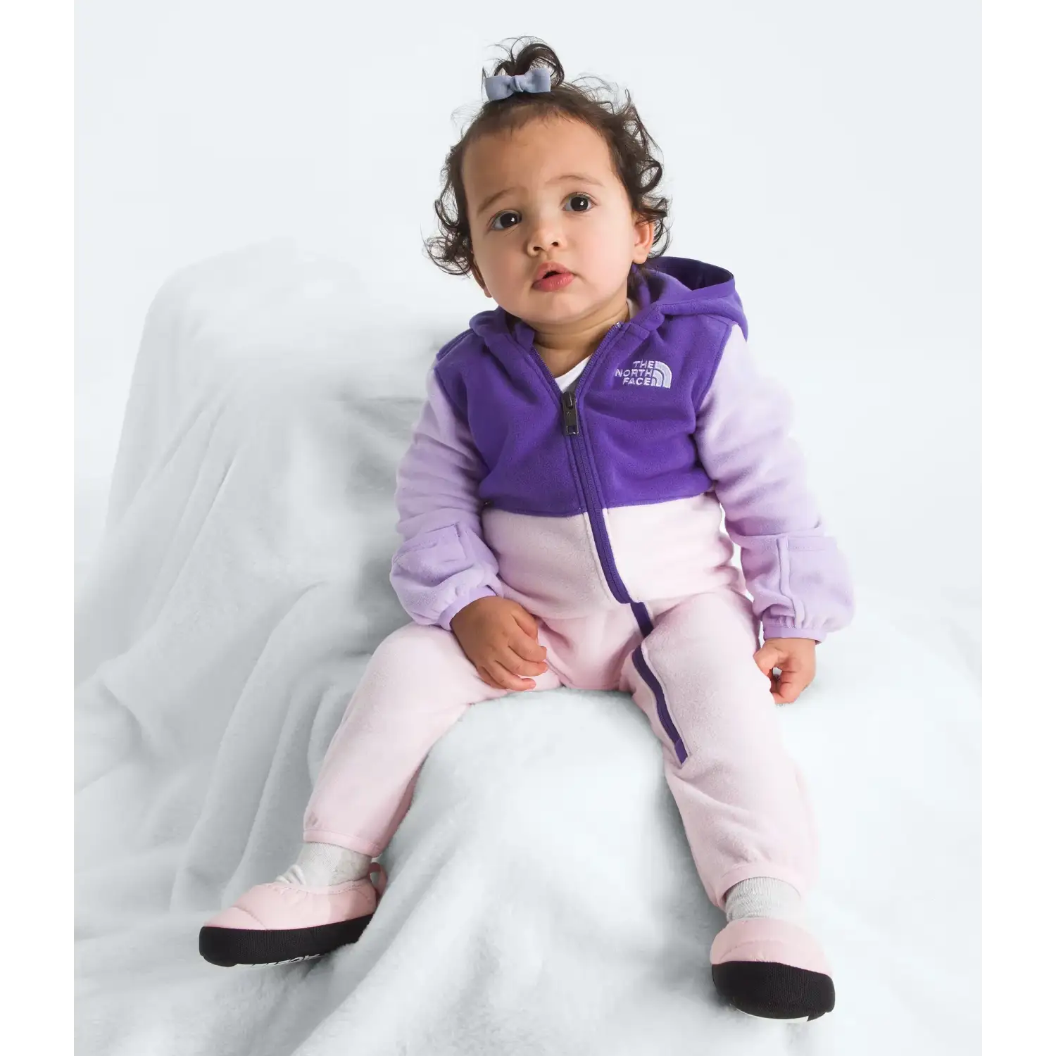 The North Face Baby Glacier One-Piece in Peak Purple Lite Lilac Pale Blossom, front view on model 
