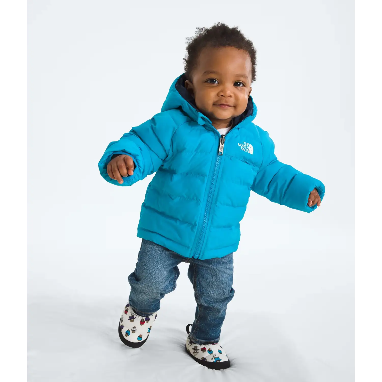 The North Face Baby Reversible Perrito Hooded Jacket in Meridian Blue, front view on model 