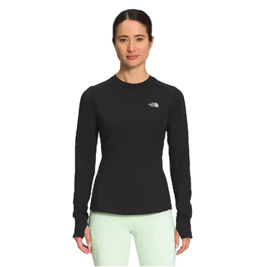 The North Face Women's Winter Warm Essential Crew shown in black on model. Front view.
