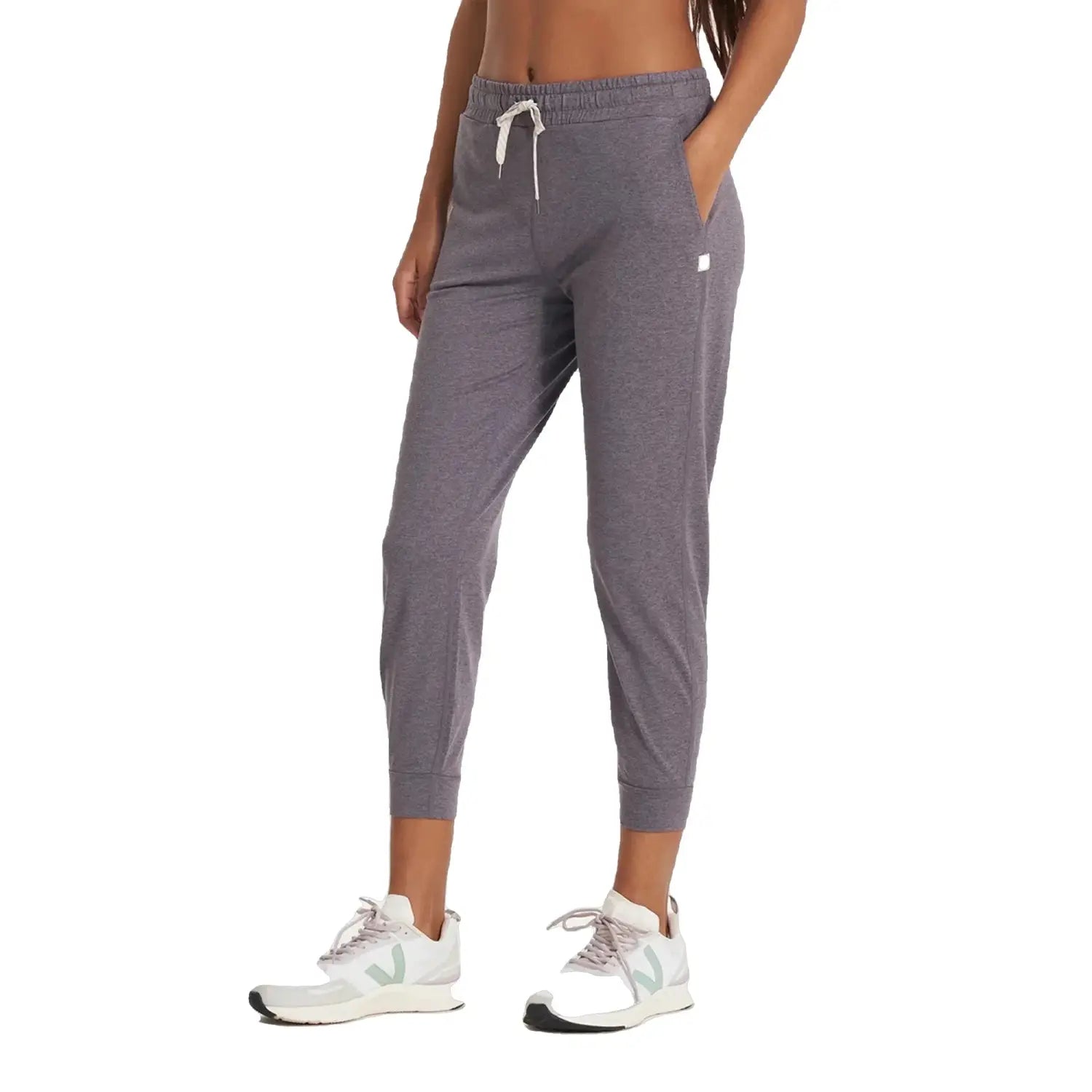 Vuori Women's Performance Jogger shown on model in Sawyer Heather, a light purple heathered color. Front View.