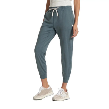Vuori Women's Performance Jogger shown on model in Lake Heather, a blue-green color with white Tie Strings. Front View.