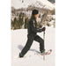 Tubbs Women's Wilderness 25 in purple, lifestyle view of woman walking though deep snow.